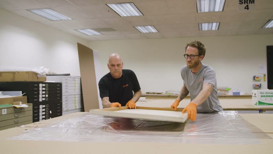 Crew blanket-wrapping furniture with care